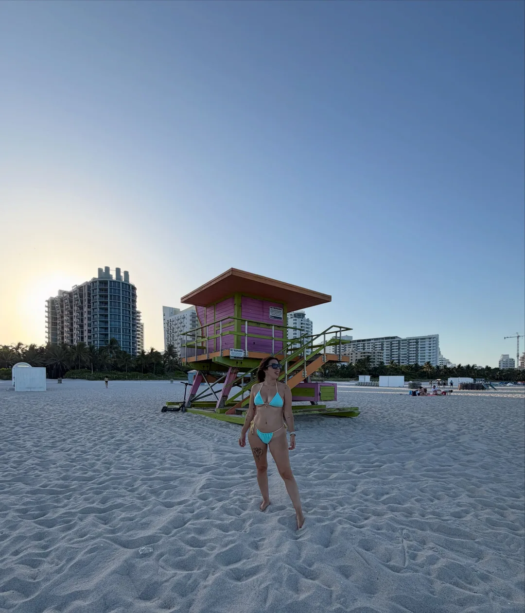 Yaiza en la playa de Miami al atardecer, junto a una caseta de socorristas